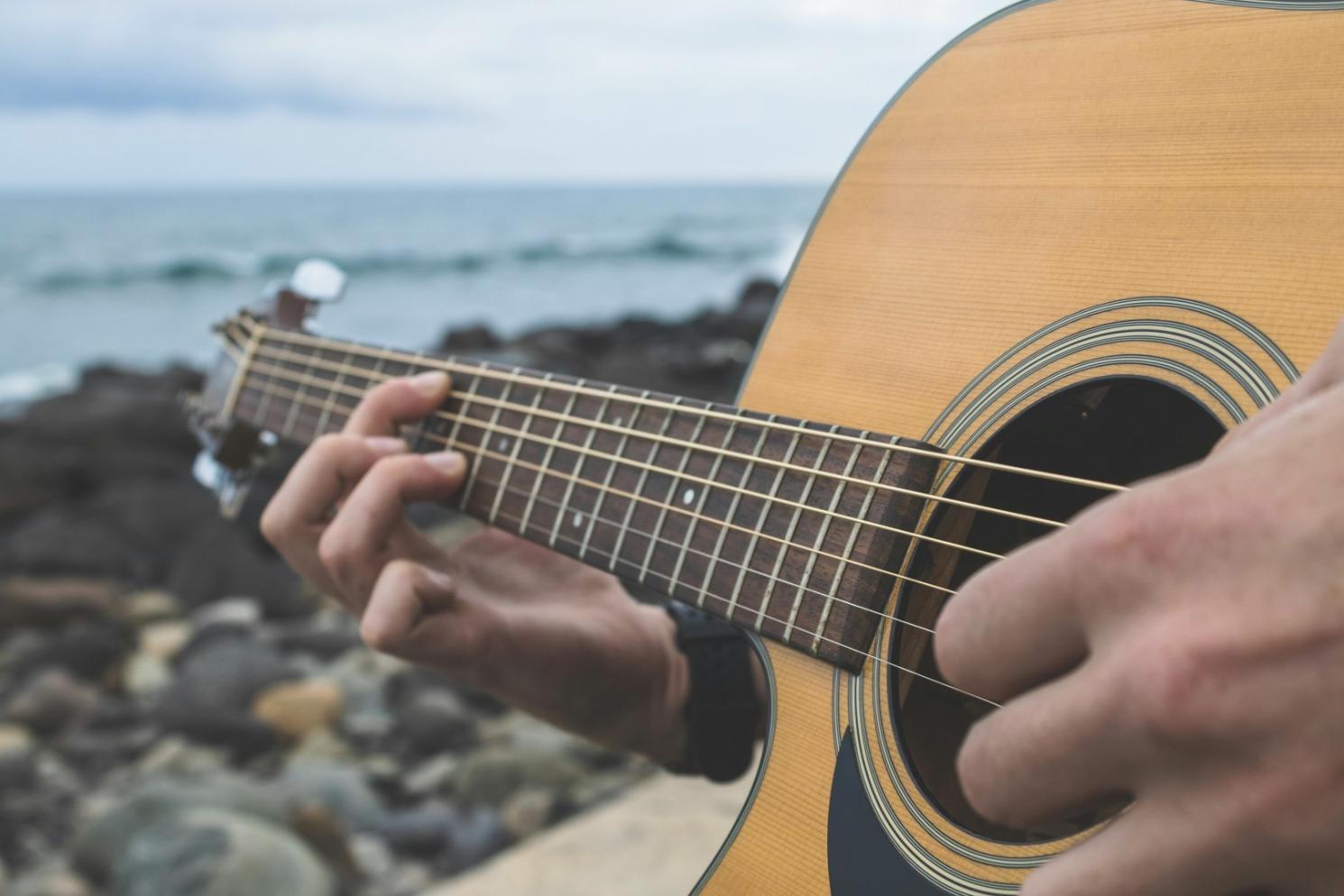 Komponist am Klavier während einer kreativen Session mit Noten und digitalem Equipment